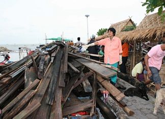 Residents point to what’s left of 81-year-old Muan Jitkawan’s house.